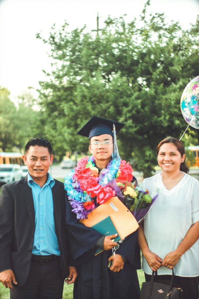 Proud parents celebrate their son's graduation with smiles and joy.